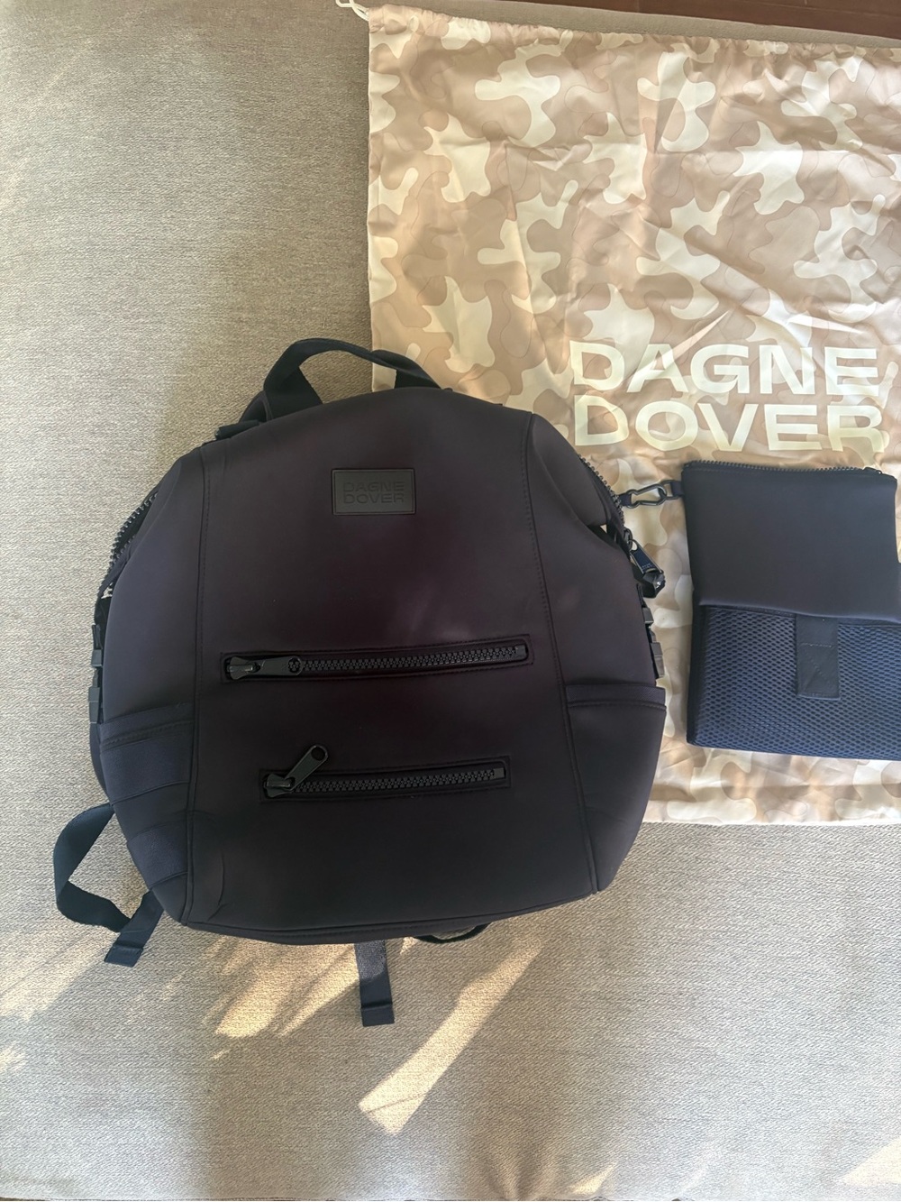 Dagne Dover Black Neoprene Round Backpack with Zip Pockets